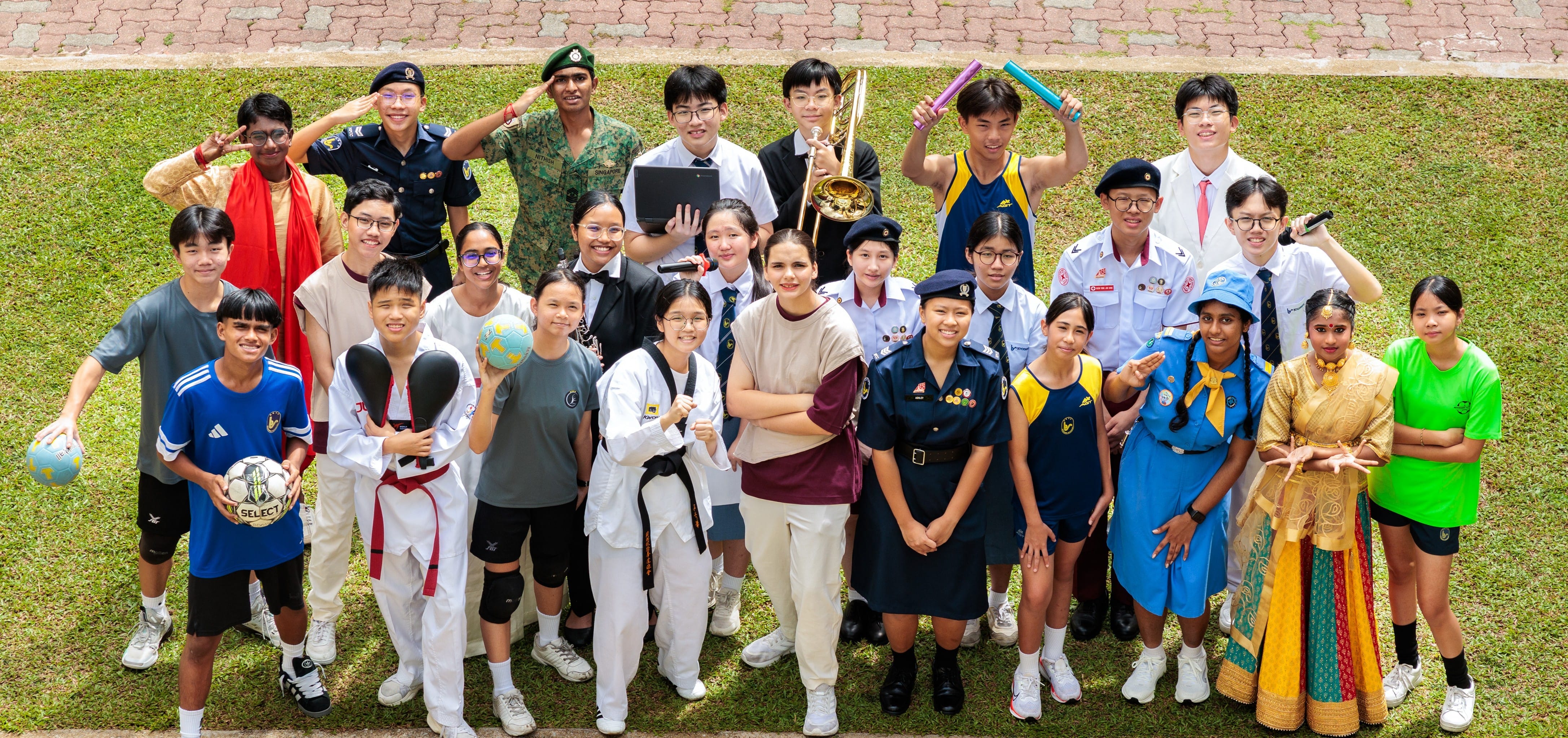 A group of students standing in CCA uniforms